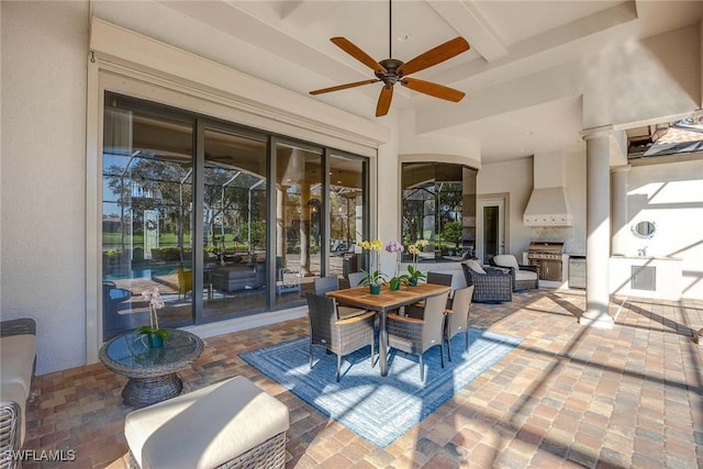 view of patio / terrace with a grill, ceiling fan, and exterior kitchen