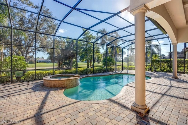 view of swimming pool with an in ground hot tub, a lanai, and a patio