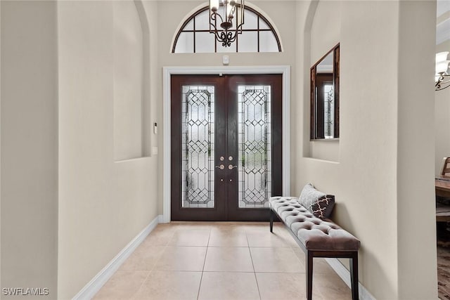 entryway featuring light tile patterned floors, a wealth of natural light, and french doors