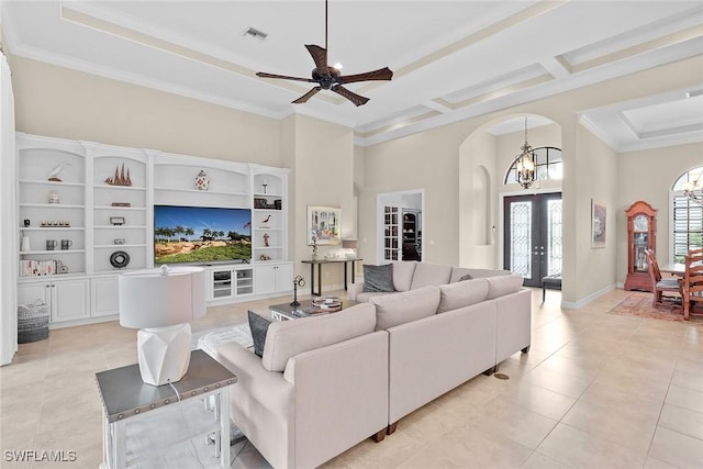 living room with coffered ceiling, ornamental molding, french doors, and a high ceiling