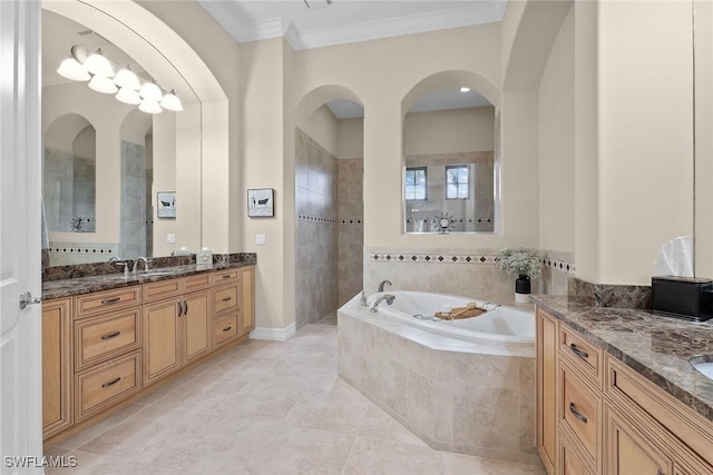 bathroom featuring vanity, a relaxing tiled tub, tile patterned floors, and crown molding