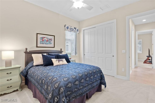 bedroom with light carpet, a closet, and ceiling fan