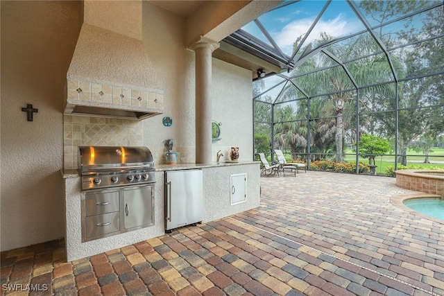 view of patio with area for grilling, a lanai, and a hot tub