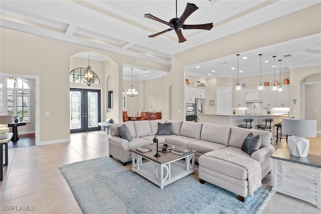 living room with light tile patterned floors, coffered ceiling, ornamental molding, french doors, and beamed ceiling