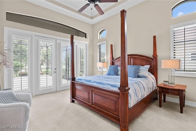 bedroom with multiple windows, access to outside, light colored carpet, and ceiling fan