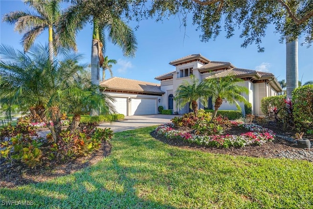7440 Byrons Way, Naples, FL 34113 - mediterranean / spanish-style home featuring a tiled roof, a garage, stucco siding, concrete driveway, and a front lawn