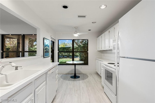6600 Tannin Ln Unit C, Naples, FL 34109 - kitchen with white cabinetry, sink, ceiling fan, and white appliances