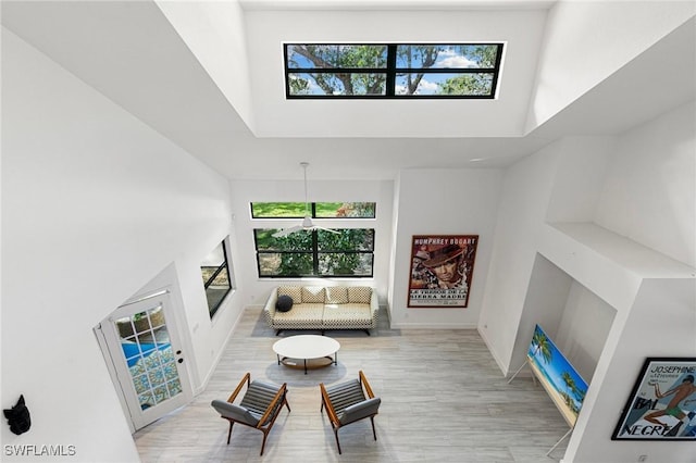 6600 Tannin Ln Unit C, Naples, FL 34109 - living room featuring a high ceiling and light hardwood / wood-style flooring