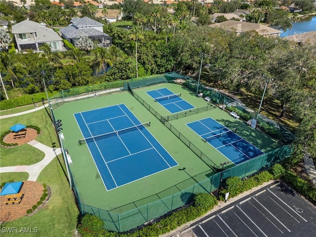6600 Tannin Ln Unit C, Naples, FL 34109 - view of sport court with a yard, a water view, and basketball hoop