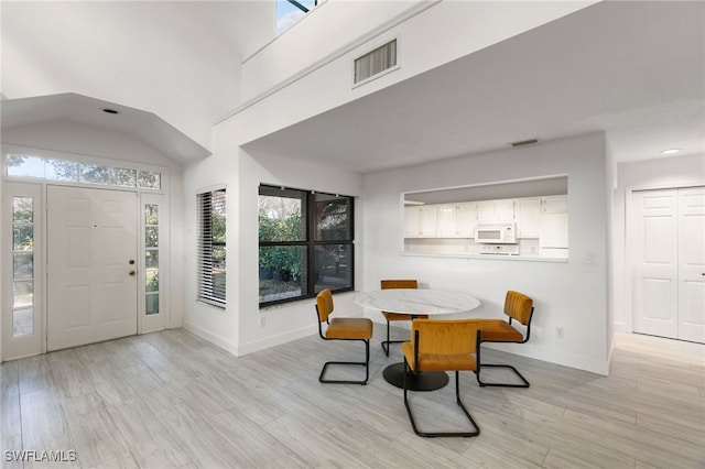 foyer entrance featuring light hardwood / wood-style floors and a healthy amount of sunlight