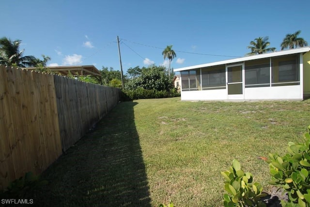 view of yard featuring a sunroom