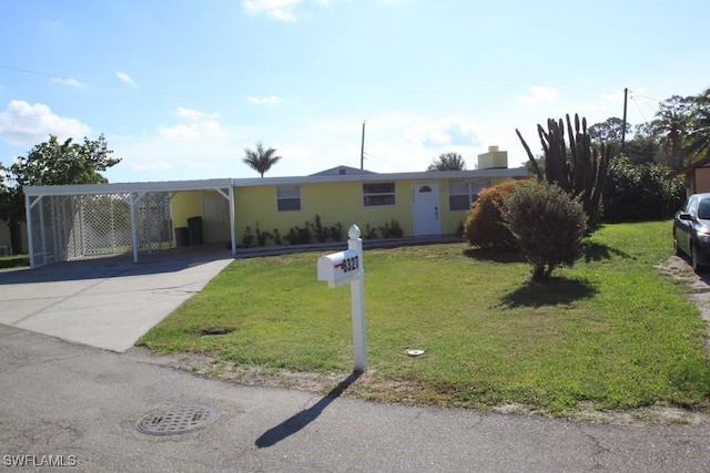 single story home with a front yard and a carport