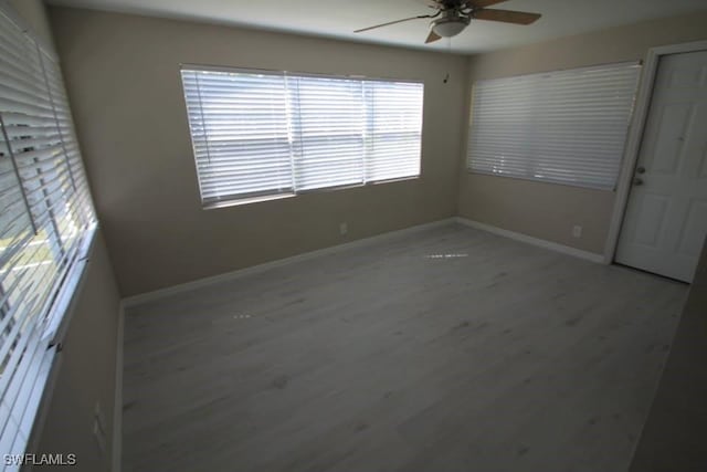 unfurnished room featuring light wood-type flooring and ceiling fan