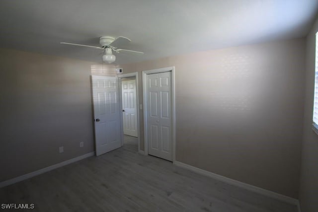 empty room with ceiling fan and wood-type flooring