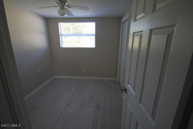 unfurnished room with ceiling fan and light wood-type flooring