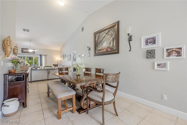 tiled dining room with ceiling fan and lofted ceiling