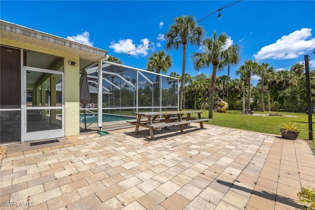 view of patio / terrace featuring a lanai