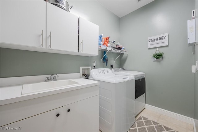 laundry room with cabinets, sink, washer and clothes dryer, and light tile patterned flooring