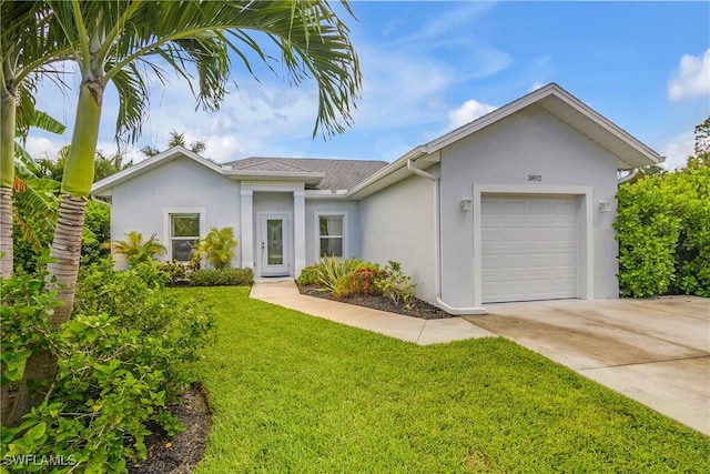 ranch-style home featuring a front lawn and a garage