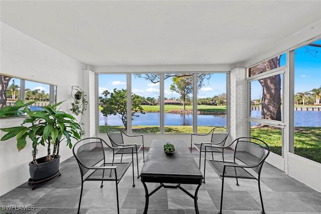 sunroom / solarium featuring a water view and plenty of natural light