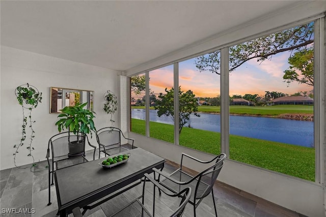 sunroom / solarium featuring a water view