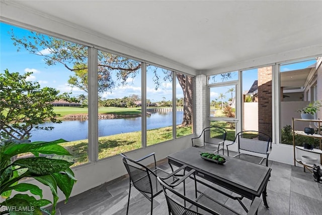 sunroom / solarium featuring a water view and a healthy amount of sunlight