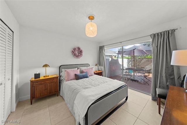 bedroom featuring access to outside, light tile patterned flooring, and baseboards