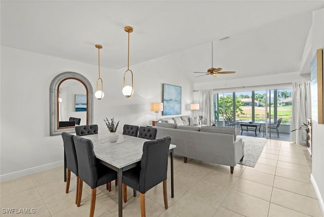 tiled dining area featuring lofted ceiling and ceiling fan