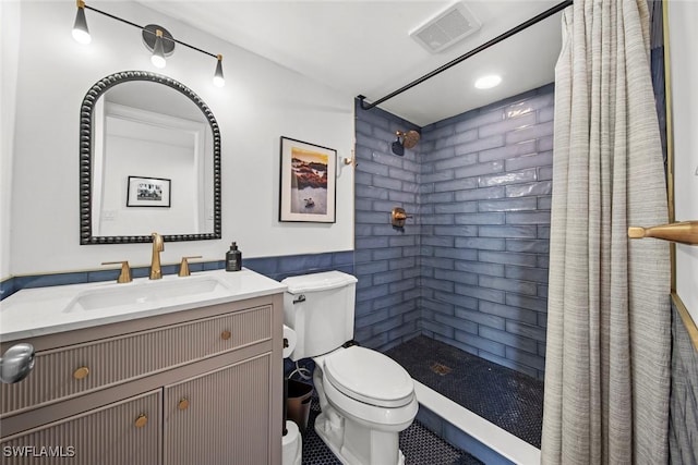 bathroom featuring walk in shower, vanity, and toilet