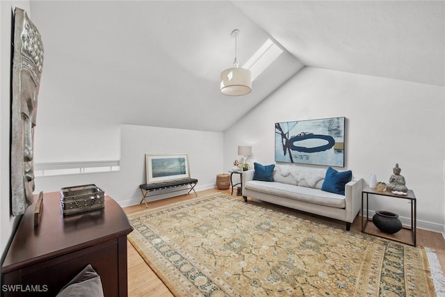 living room featuring vaulted ceiling, wood finished floors, and baseboards