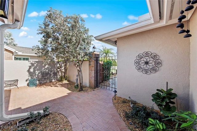 view of patio with a gate and fence