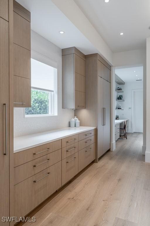 kitchen featuring light brown cabinets and light hardwood / wood-style flooring