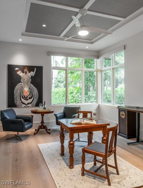 living area featuring ceiling fan, plenty of natural light, and light hardwood / wood-style flooring