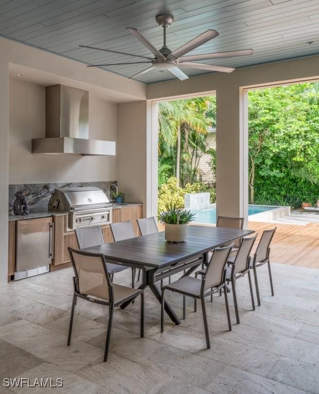 view of patio / terrace featuring grilling area, ceiling fan, and an outdoor kitchen