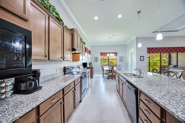 kitchen featuring light stone countertops, ornamental molding, stainless steel appliances, sink, and pendant lighting