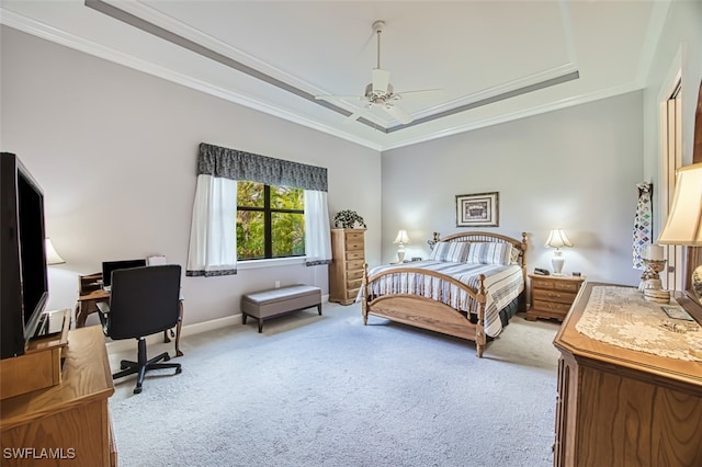 carpeted bedroom featuring a tray ceiling, ceiling fan, and ornamental molding