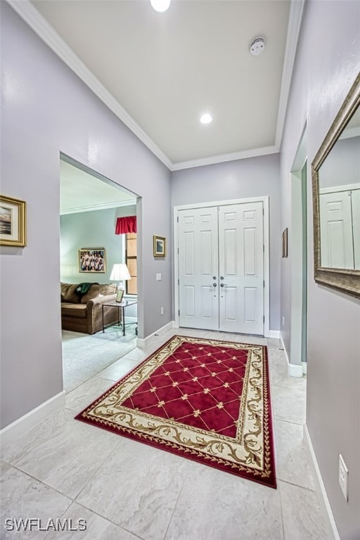 foyer featuring tile patterned flooring and crown molding