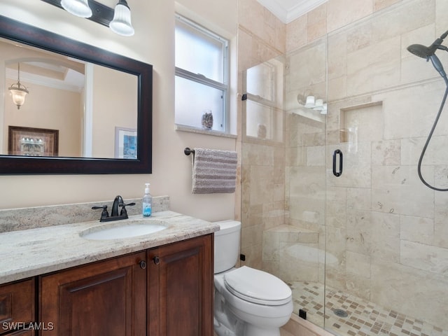 bathroom with crown molding, vanity, an enclosed shower, and toilet