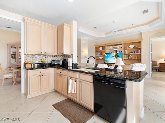 kitchen with kitchen peninsula, dark stone counters, a tray ceiling, and dishwasher