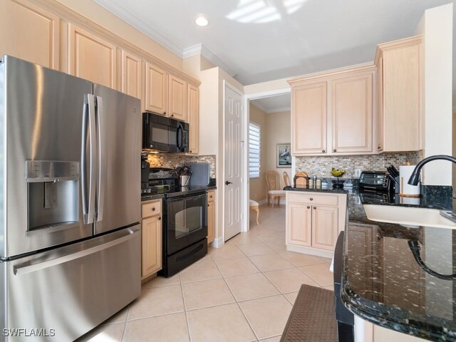 kitchen with light tile patterned floors, sink, crown molding, and black appliances