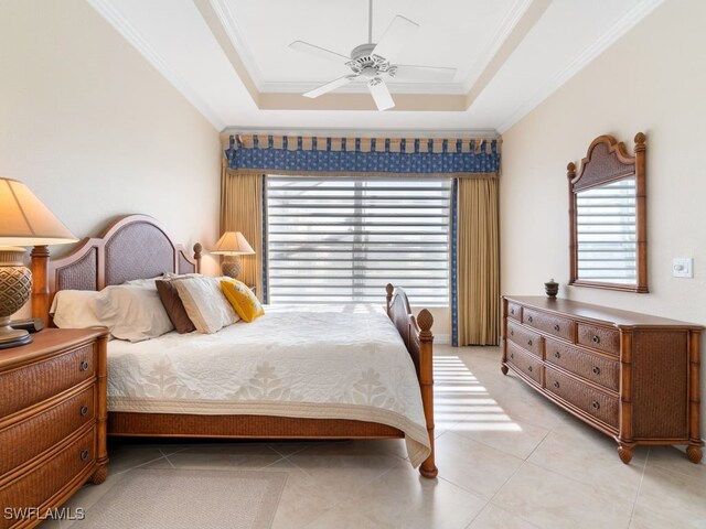 bedroom with a tray ceiling, ceiling fan, crown molding, and light tile patterned floors