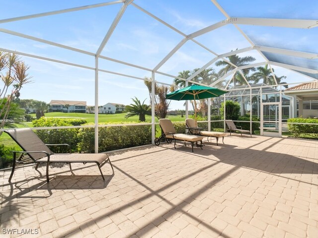 view of patio / terrace featuring a lanai