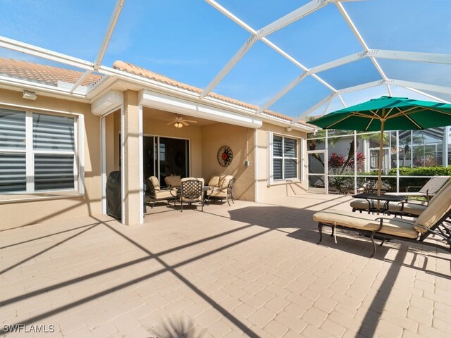 view of patio / terrace featuring ceiling fan and a lanai