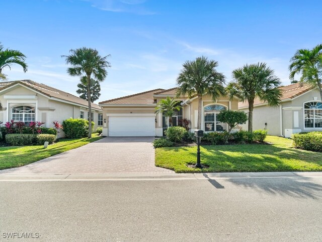 view of front of house featuring a front yard and a garage