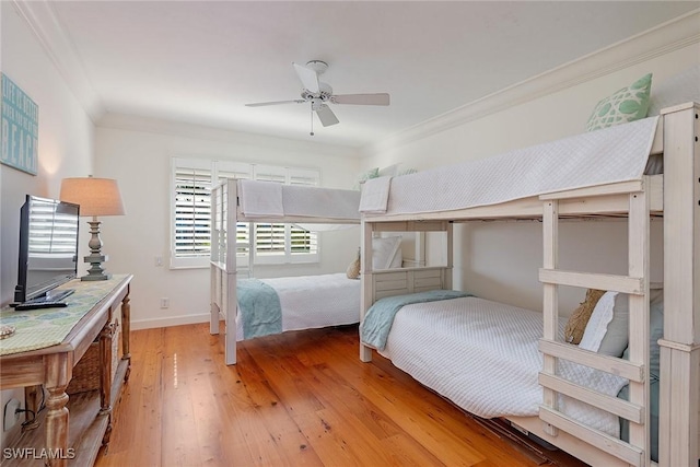 bedroom with ceiling fan, crown molding, and light hardwood / wood-style floors