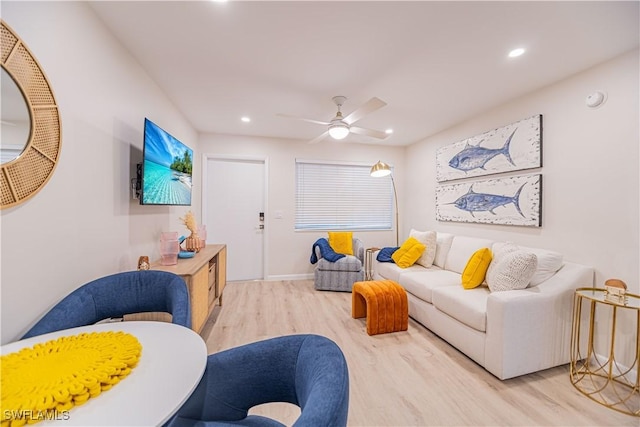 living room featuring hardwood / wood-style floors and ceiling fan