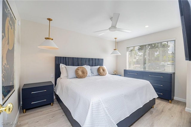 bedroom with light wood-type flooring and ceiling fan