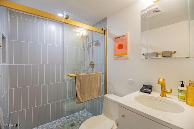 bathroom featuring an enclosed shower, vanity, and toilet