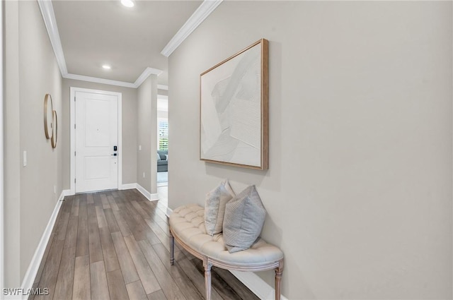 hall featuring ornamental molding and hardwood / wood-style floors