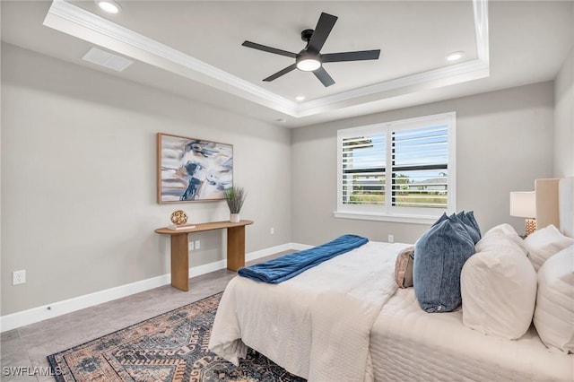 bedroom featuring ceiling fan, crown molding, and a tray ceiling